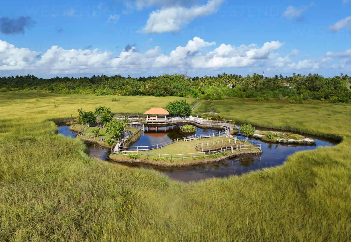 Aerial view of Mathikilhi Eco Garden Meedhoo with hut, swamp, and lake, Addu Atoll, Maldives.